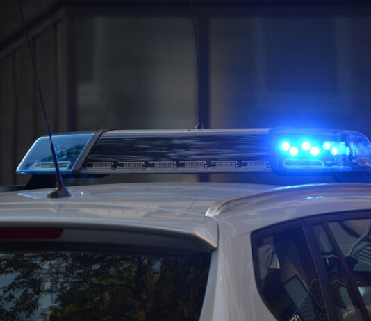 police car flashing sirens at scene of accident