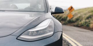 Black Tesla driving on highway