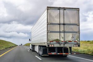 Driver Hospitalized After Being Pinned Between Two Semi-trucks in Crash